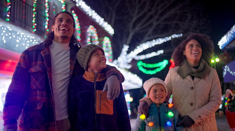 a family enjoys Holiday Lights